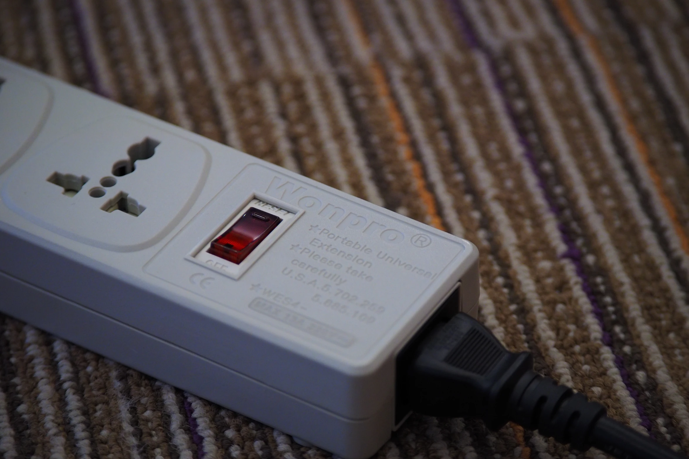 closeup po of electronic device sitting on striped cloth