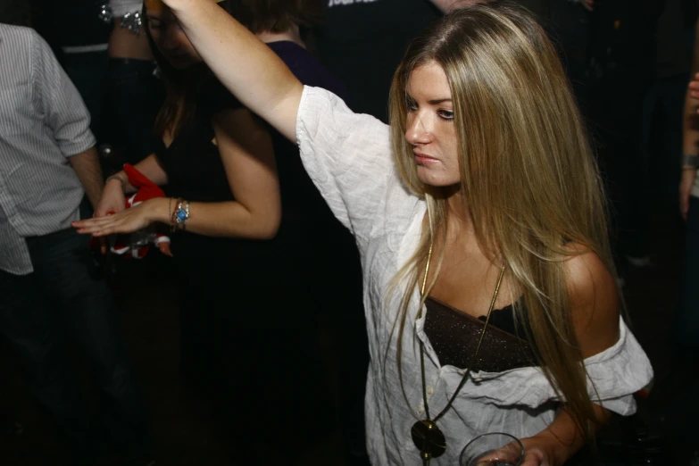 a woman standing next to another woman at a party