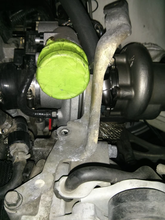 a closeup of a green bowl sitting on the engine