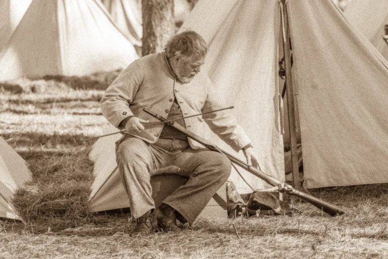 an old fashioned po of a man holding a rifle