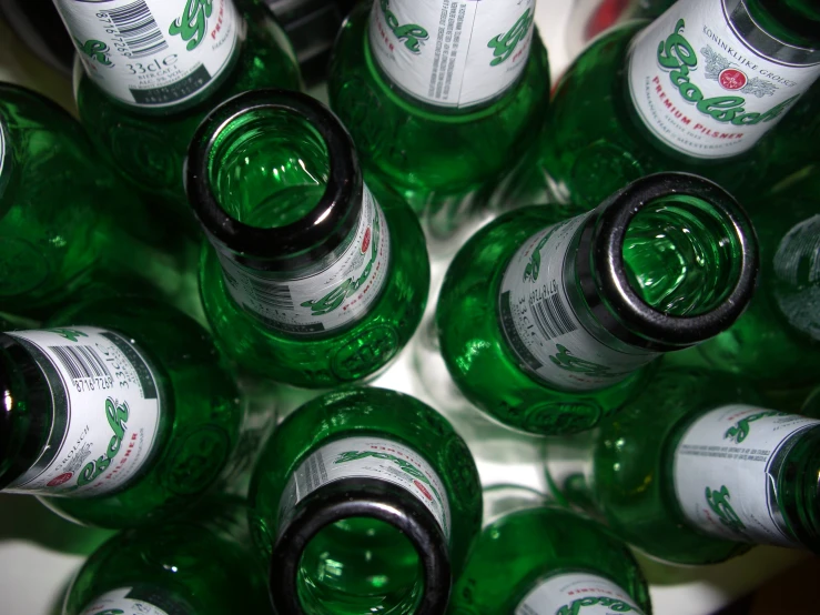 many green and white bottles of different sizes