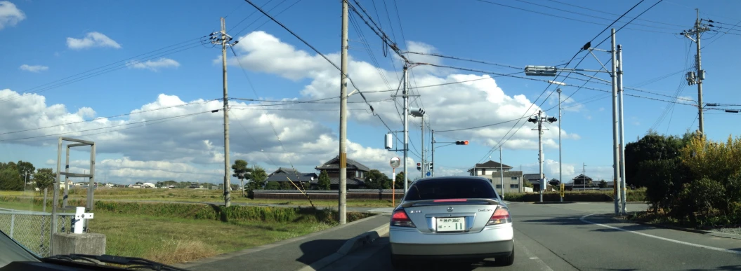 a car drives down an open road on a cloudy day