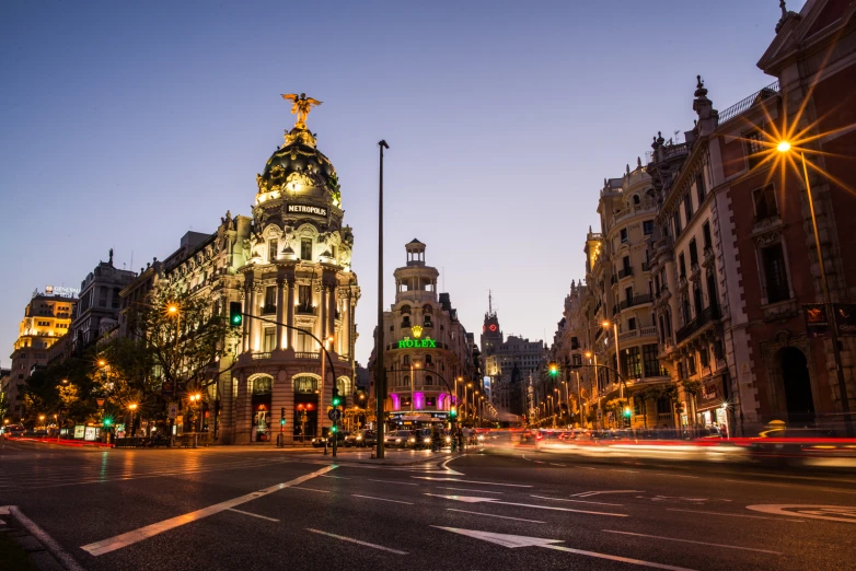 a city street with cars and light up buildings