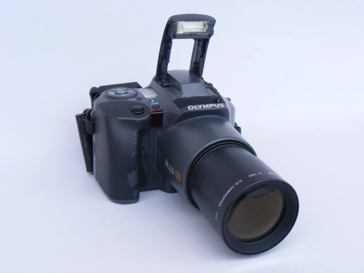a camera and flash light on a white surface