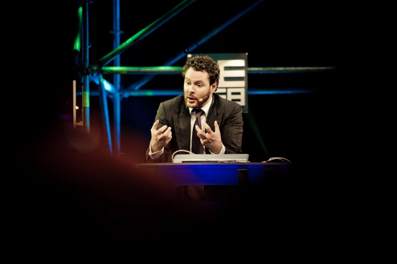 a man with a microphone on a podium