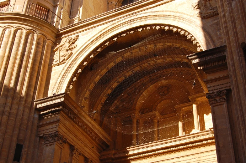 the entrance to a large building, with ornate statues