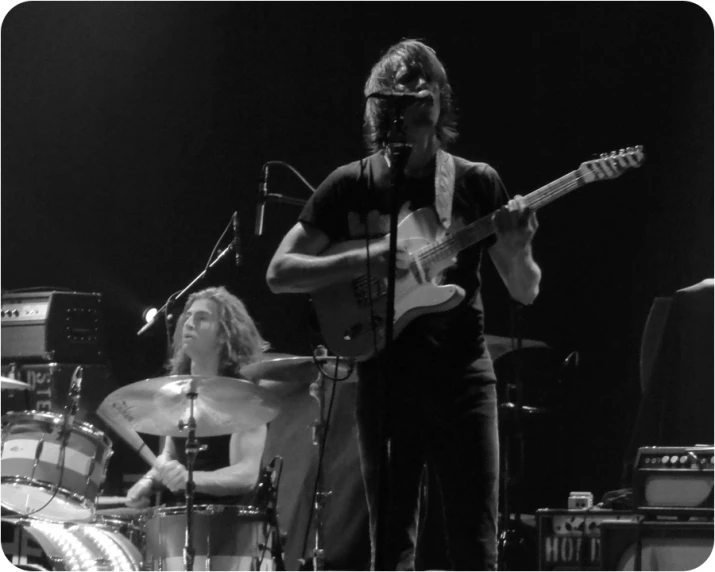 two guys on stage playing guitar and singing