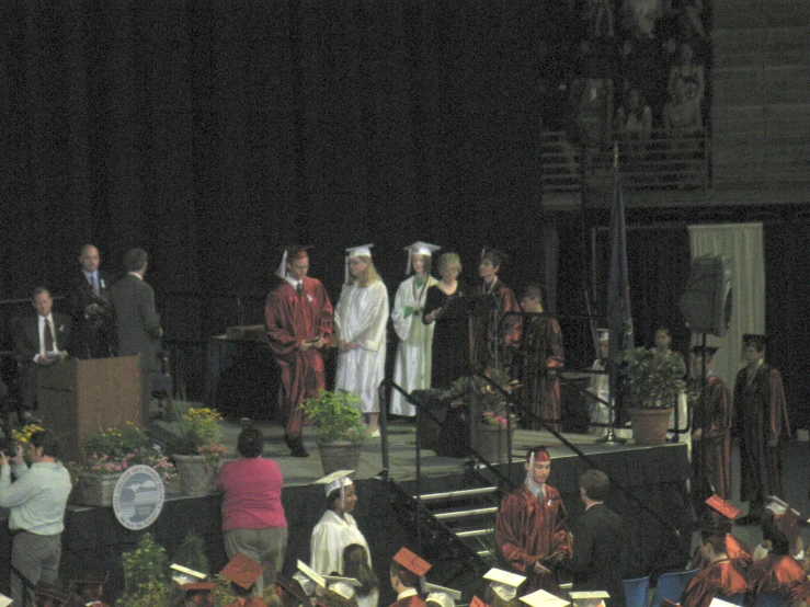 an outdoor event with people on the steps and some are performing