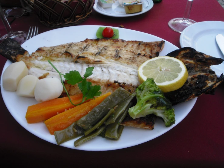 a plate with fish, vegetables and potatoes