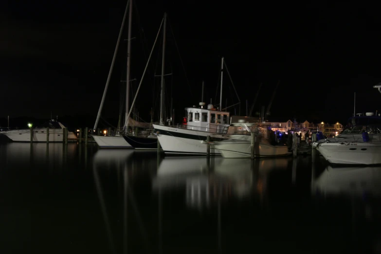 a fleet of yachts at the docks in a city