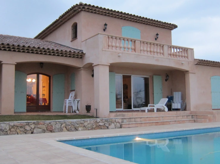 the front of a home with a pool in front