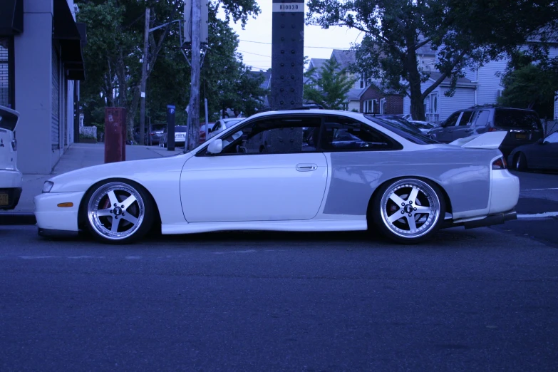 a car is parked next to some white cars