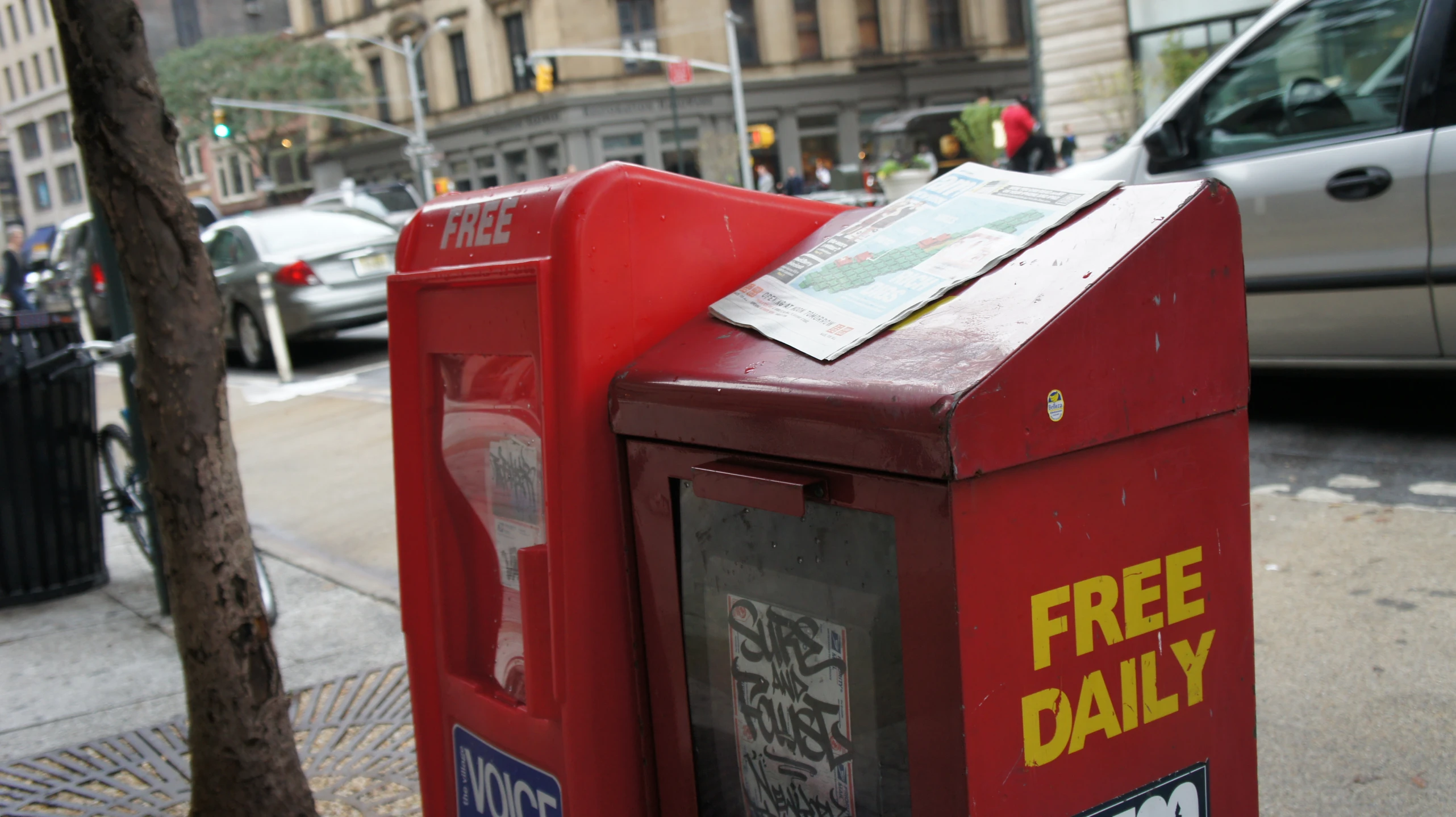 there is a red box on the side of a street