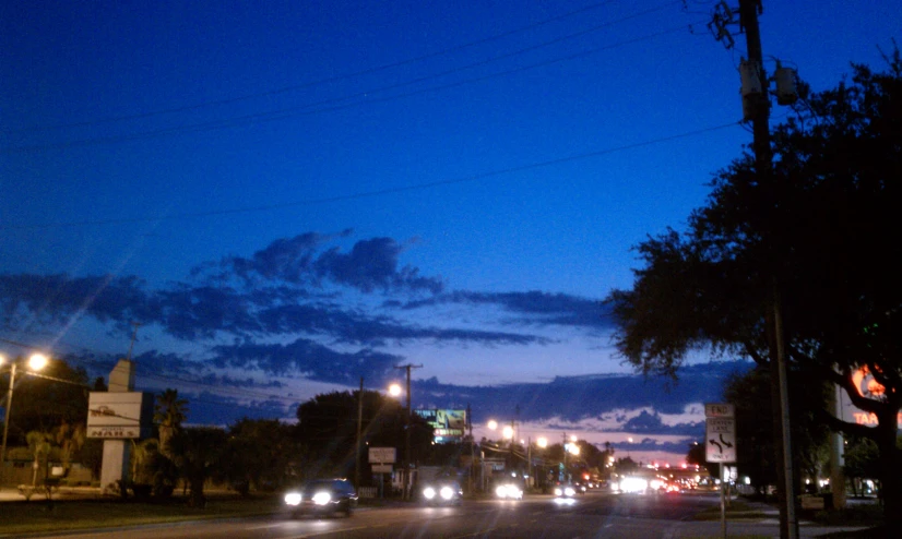 a busy street is at dusk during the day