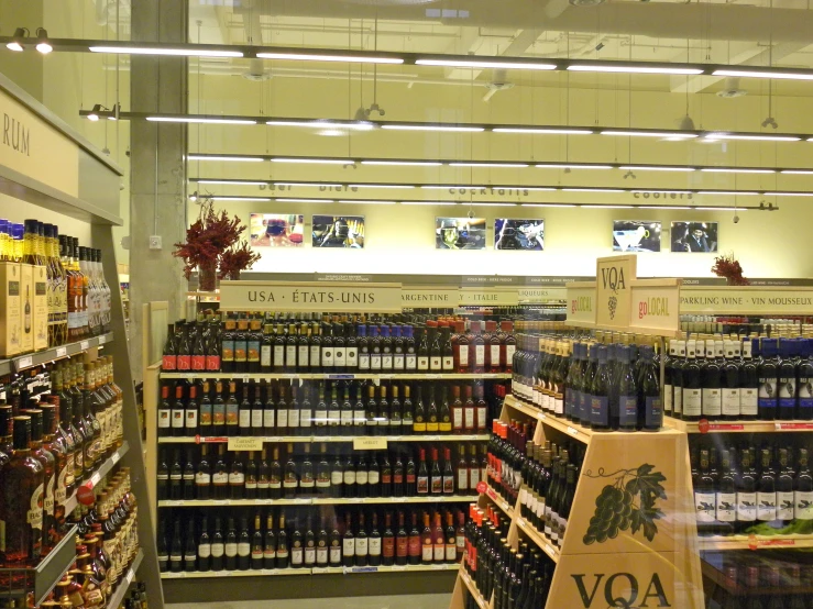 there are bottles of various wine on shelves in the store