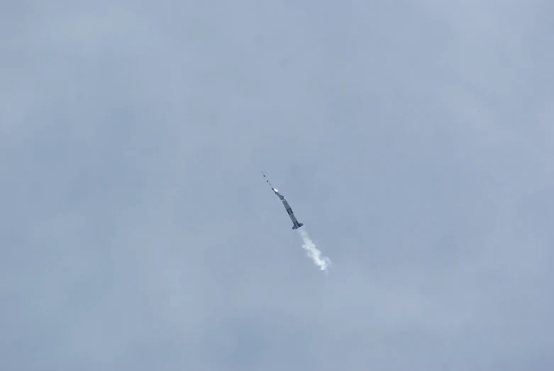 an airplane is flying through the clear sky