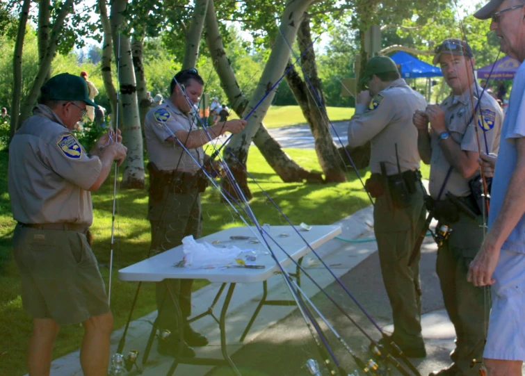 a group of men standing around a table