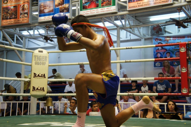 a man with  standing next to a boxing ring