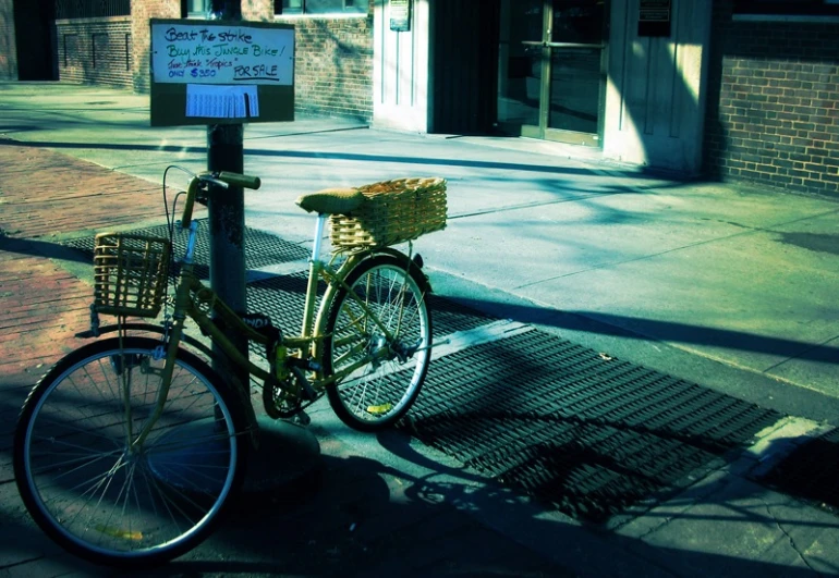 a bike sitting parked on the side of a road