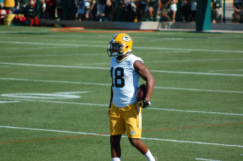 a person that is standing on a field with a helmet