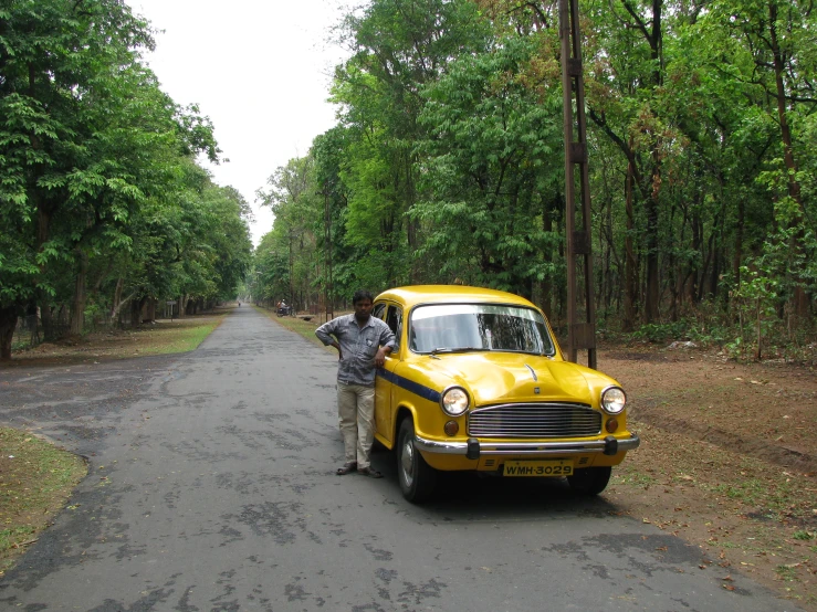 an old car that is parked in the street