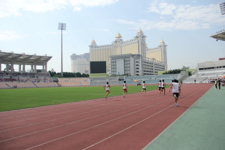 a group of people running across a track