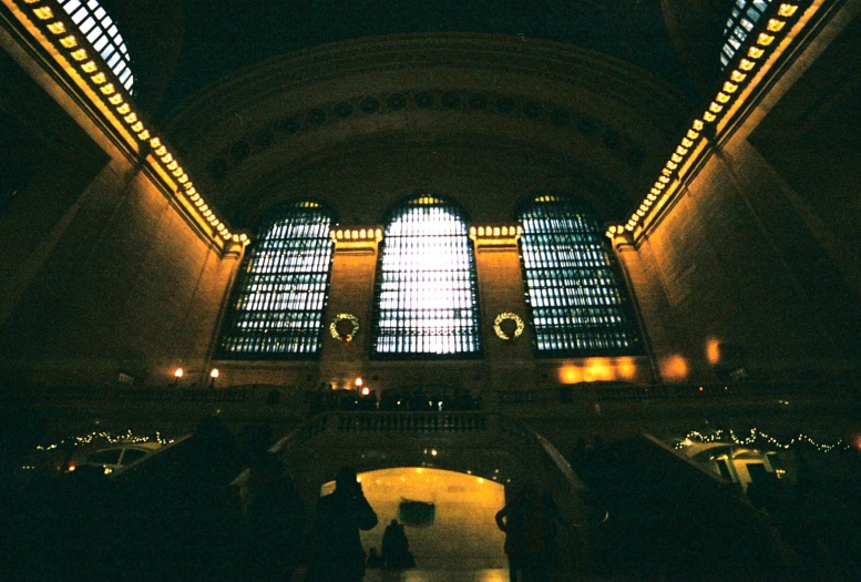 a building with multiple tall windows next to walkway