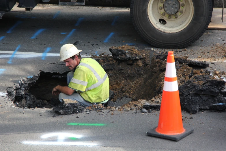 a worker is examining the work area for possible damage