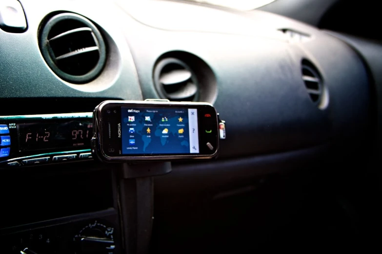 a cellphone is in the holder and it's attached to a car dashboard