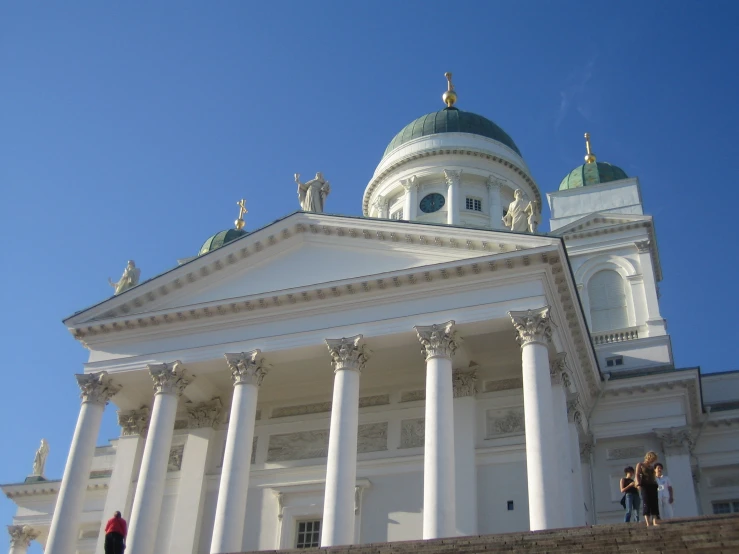 two people are walking up the stairs to a building