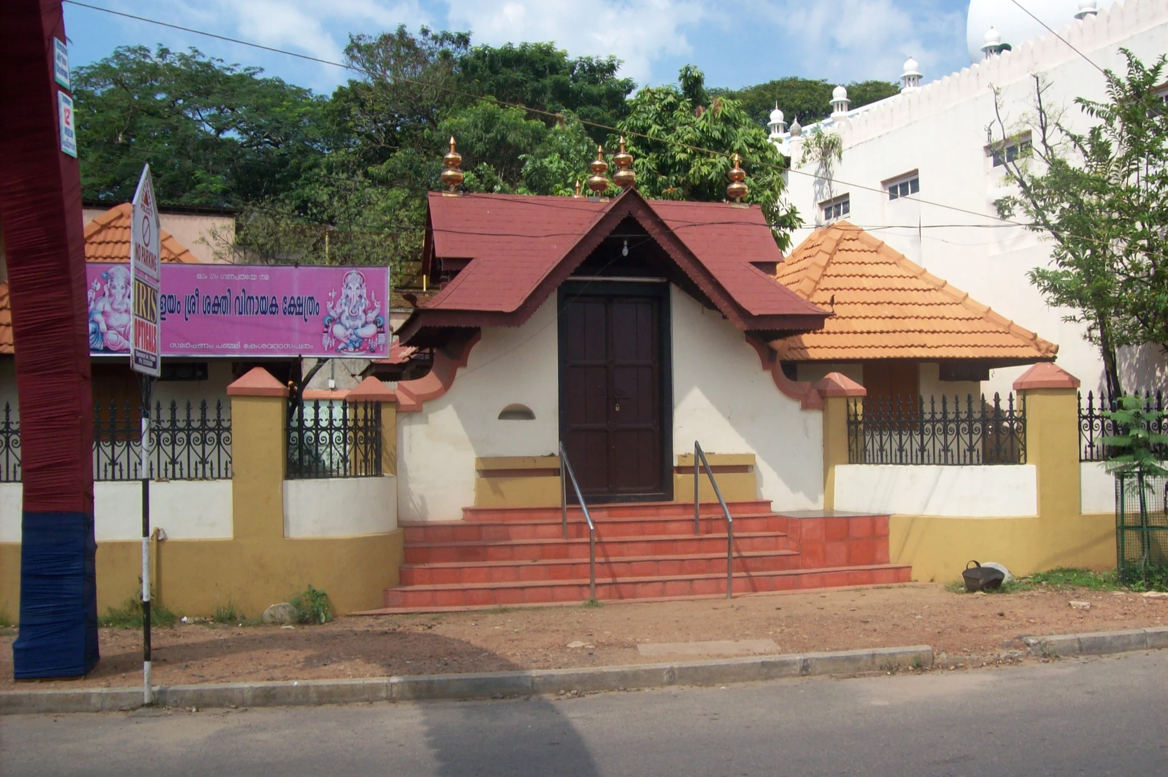 a building with a sign attached to the front and the stairs