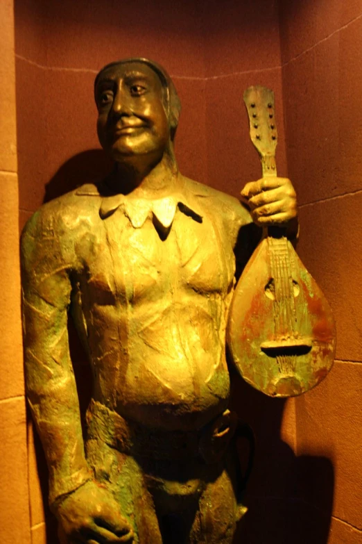 this is a bronze statue of a man holding a guitar