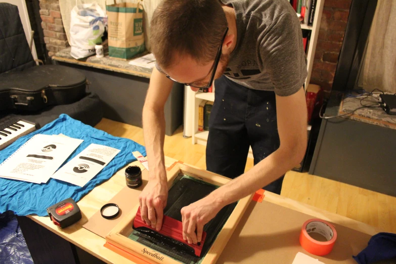 a man uses an electronic device to examine a book