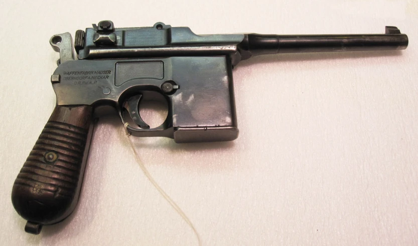 an old gun resting on a white background