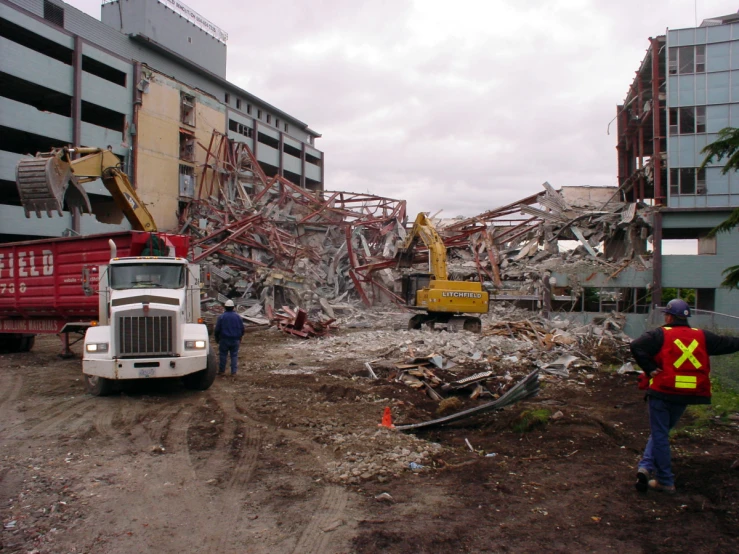 a man standing near a big white truck