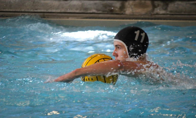 a person with water polo ball in the pool