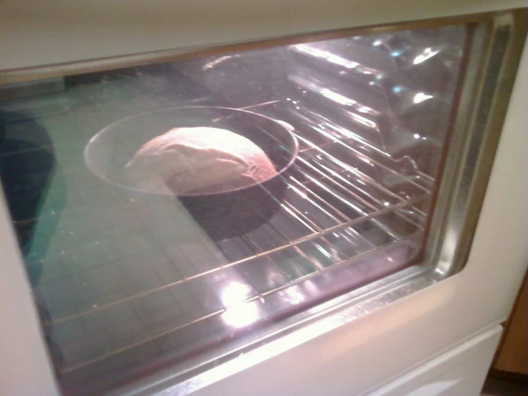 a person is baking a pie in an oven