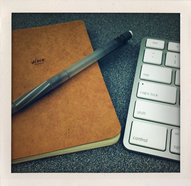 a pen is sitting on top of an open notebook