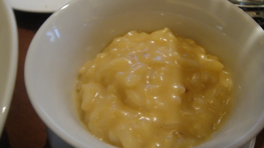 an oatmeal is in the white bowl sitting on the table