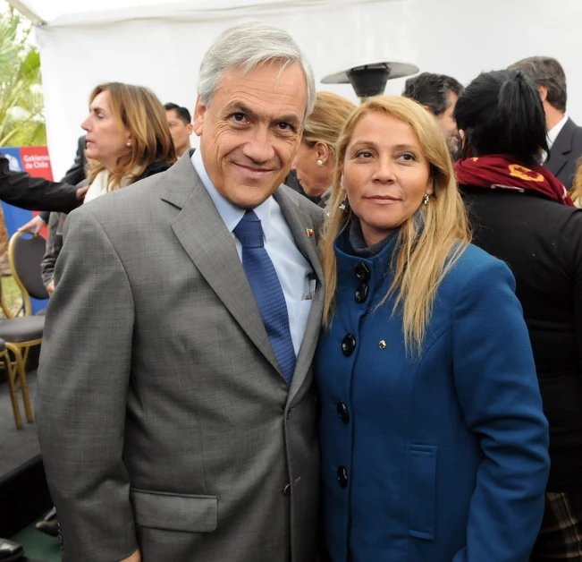 an older couple in formal wear pose for the camera