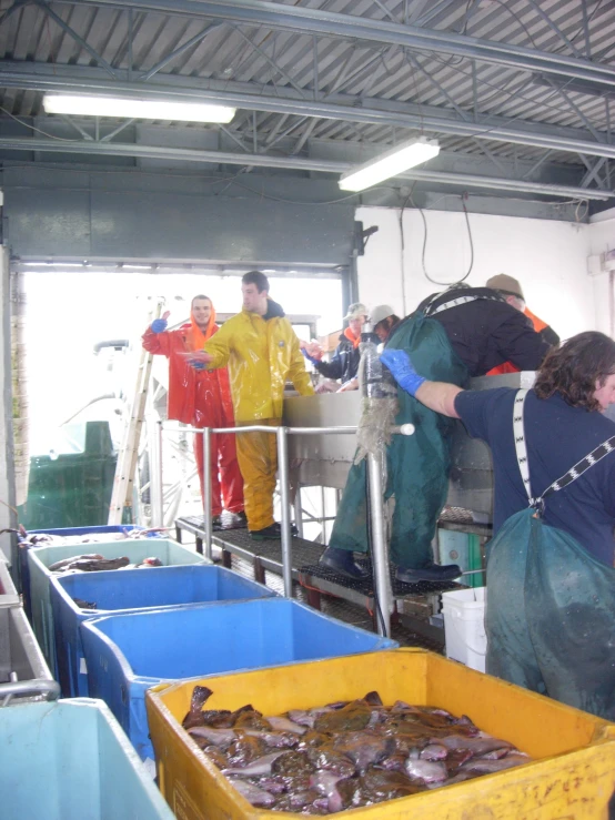 a group of workers are putting together a container