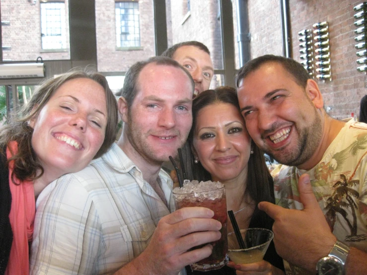 a group of people posing with drinks at a beer bar