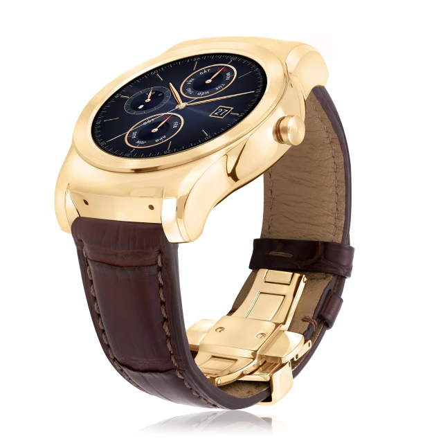 a gold watch with brown leather straps