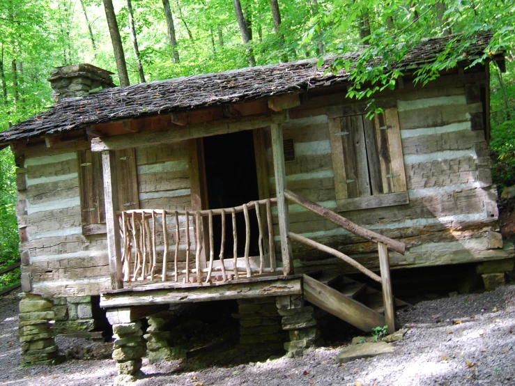 a cabin with wooden steps leading to the entrance