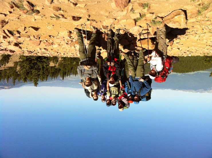 a group of people are standing on rocks in the wilderness