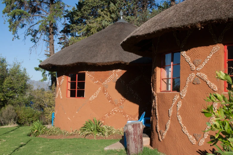 a brown building that has a thatched roof