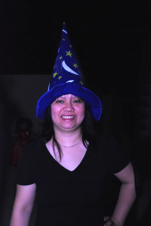 a smiling woman in a blue hat with stars