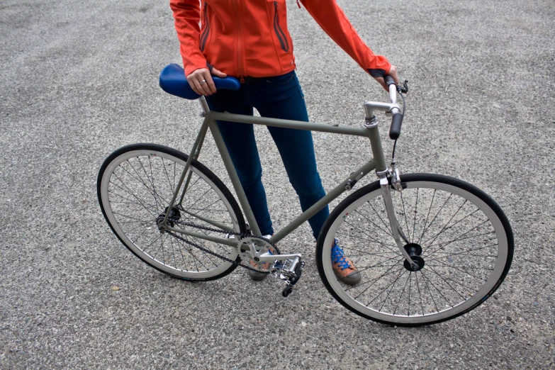 there is a woman standing by her bike