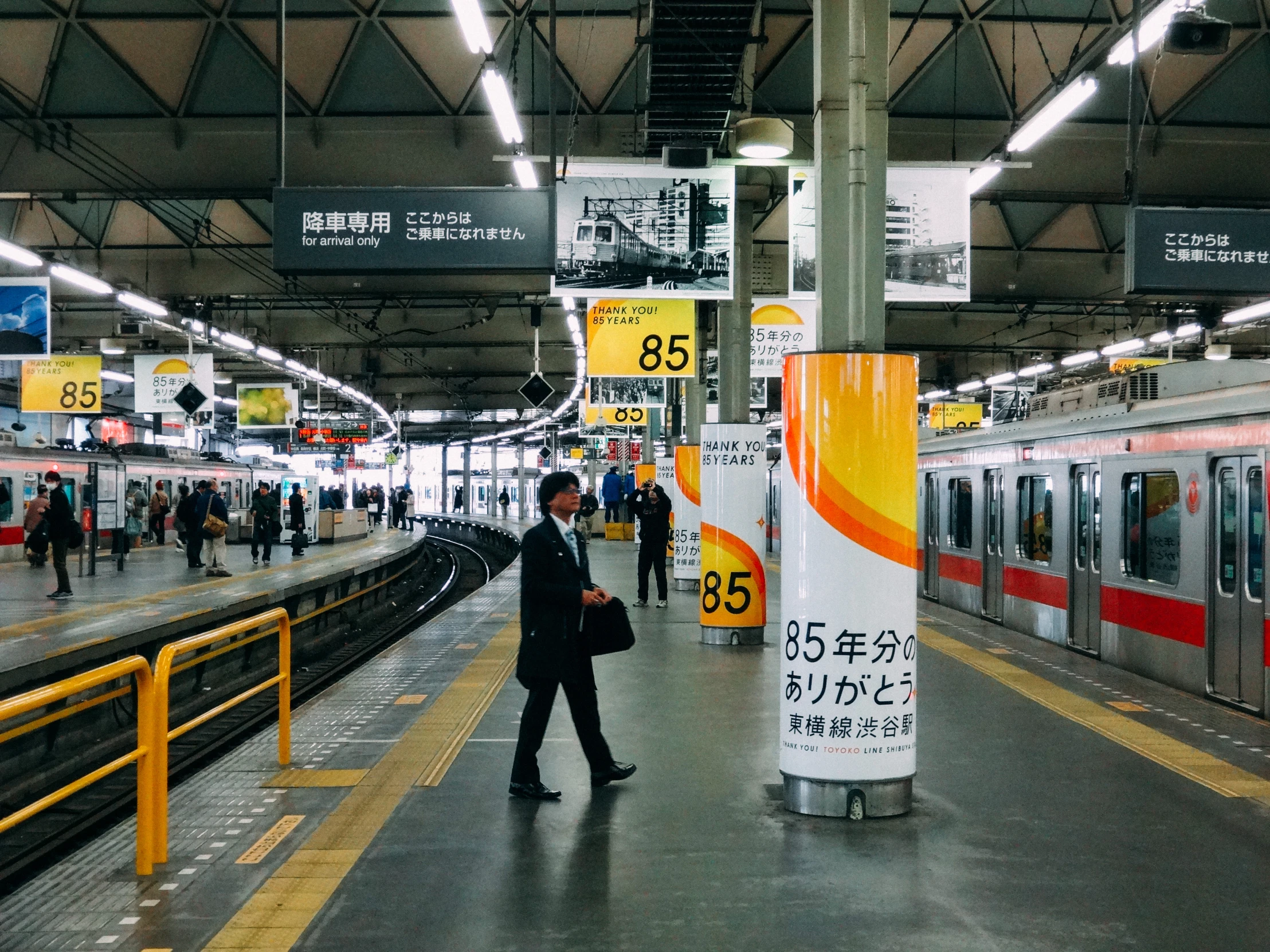 a man in a suit and white shirt in a train station