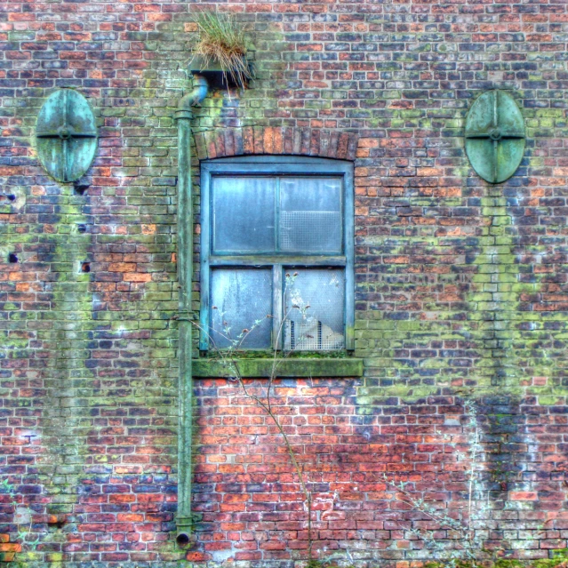 an old window is set in to an old brick building